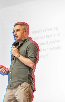 Speaker presenting on stage at SEO IRL